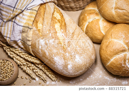 Fresh bread and wheat on a rustic background 88315721