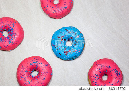 Delicious glazed donuts with sprinkles on light background 88315792