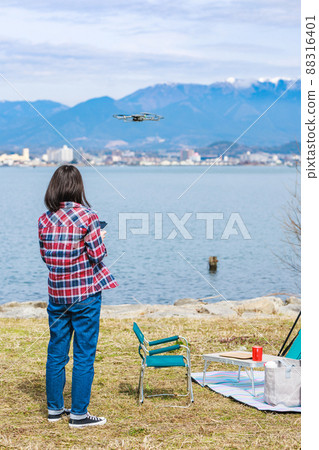 Woman steering drone 88316401