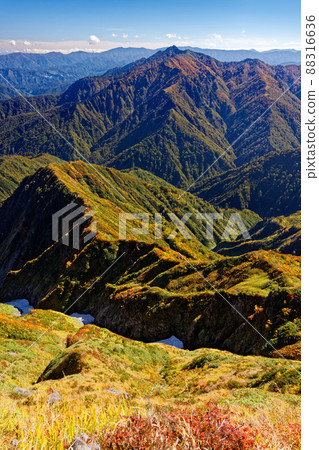 Mt. Arasawa seen from the ridgeline of Mt. Echigo Komagatake in autumn colors 88316636