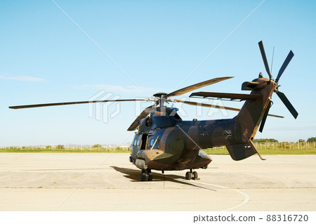 Ready for take-off. A military helicopter standing on a launchpad. 88316720