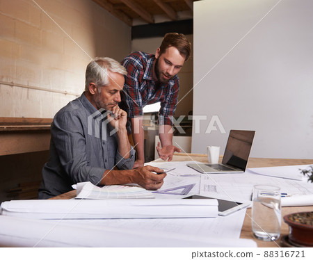 Turning his vision into reality. An architect drawing up plans. 88316721