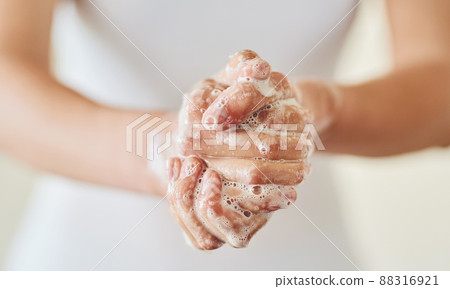 Keep clean and safe from germs. Closeup shot of a woman washing her hands with soap. 88316921