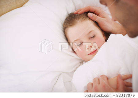 Safely tucked in. A dad lovingly putting his daughter to bed. Safely tucked in. A dad lovingly putting his daughter to bed. 88317079