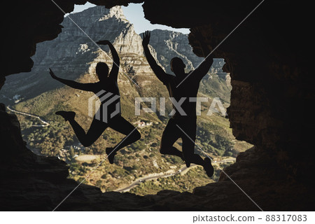 We did it. Rearview shot of a young couple jumping in excitement while hiking in the mountains. We did it. Rearview shot of a young couple jumping in excitement while hiking in the mountains. 88317083