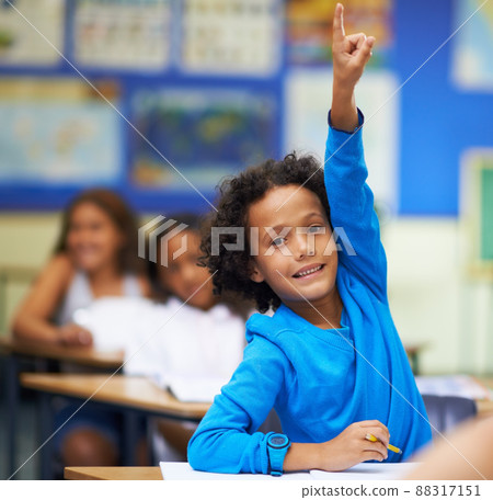 Pick me I know the answer. A little boy raising her hand in class. Pick me I know the answer. A little boy raising her hand in class. 88317151