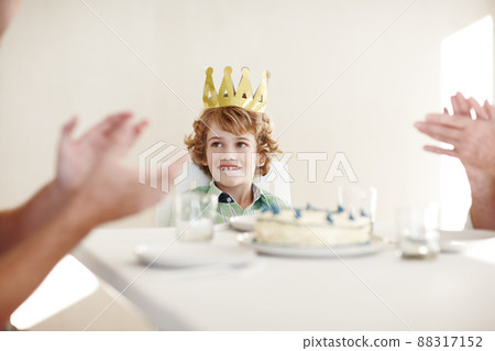 The king loves the attention. Shot of two people clapping hands for the birthday boy. The king loves the attention. Shot of two people clapping hands for the birthday boy. 88317152