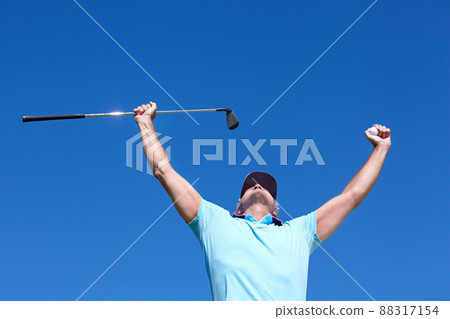Hole in one. Low-angle shot of a mature male golfer with his arms raised in celebration. Hole in one. Low-angle shot of a mature male golfer with his arms raised in celebration. 88317154