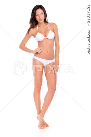 Shes sizzling hot this summer. Studio shot of a beautiful brunette model in a bikini isolated on white. Shes sizzling hot this summer. Studio shot of a beautiful brunette model in a bikini isolated on white. 88317155