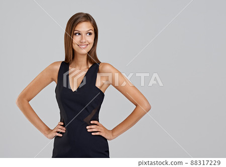 Today she can take on anything. Studio shot of an attractive young woman on a grey background. Today she can take on anything. Studio shot of an attractive young woman on a grey background. 88317229