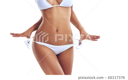 Bikini season is here. Cropped studio shot of a woman in a bikini isolated on white. Bikini season is here. Cropped studio shot of a woman in a bikini isolated on white. 88317376