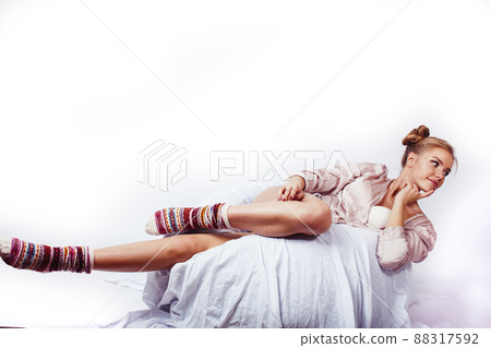 young pretty blond woman laying in bed isolated on white background, lifestyle people concept young pretty blond woman laying in bed isolated on white background, lifestyle people concept 88317592