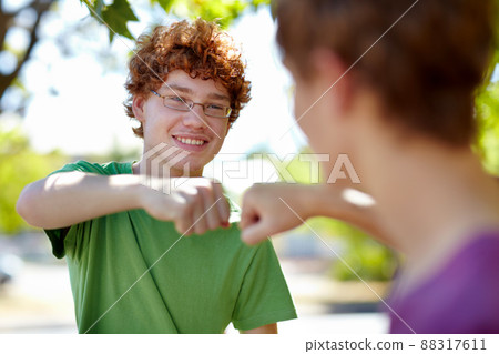 Best bud bump. Cropped shot of two teenage boys fist bumping. Best bud bump. Cropped shot of two teenage boys fist bumping. 88317611