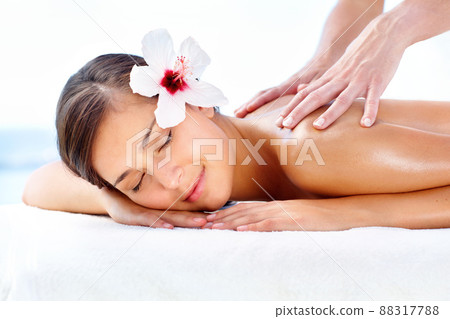 Lost in spa bliss. Gorgeous young woman relaxing during a spa massage. Lost in spa bliss. Gorgeous young woman relaxing during a spa massage. 88317788