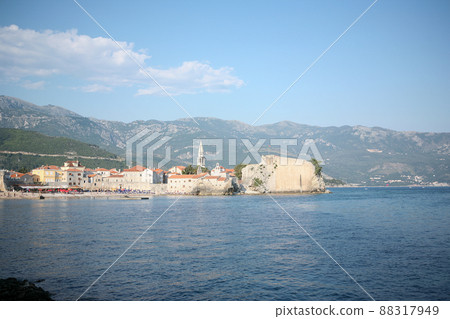 View of old town Budva on mountains background, Montenegro. The resort city located in Budva Riviera of Adriatic Sea for poster, branding, calendar, multicolor card, banner, cover, post, website. A View of old town Budva on mountains background, Montenegro. The resort city located in Budva Riviera of Adriatic Sea for poster, branding, calendar, multicolor card, banner, cover, post, website. A 88317949