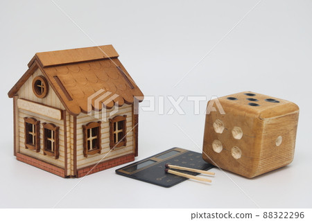 Homemade dice and matches next to a toy house, the concept of uncertainty 88322296