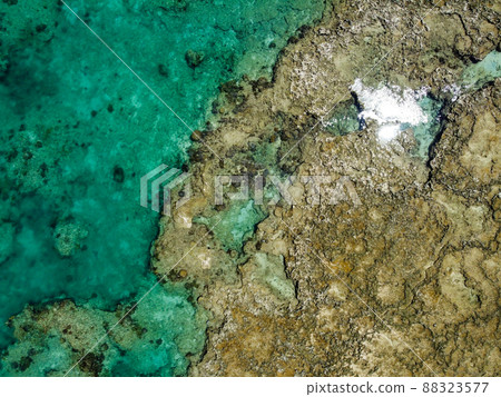 Photograph from the sky of the tidal flat at low tide of the clear sea of Ikei Island, Uruma City, Okinawa Prefecture on a sunny day Photograph from the sky of the tidal flat at low tide of the clear sea of Ikei Island, Uruma City, Okinawa Prefecture on a sunny day 88323577