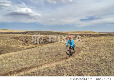 senior male cyclist is riding a gravel bike senior male cyclist is riding a gravel bike 88324264
