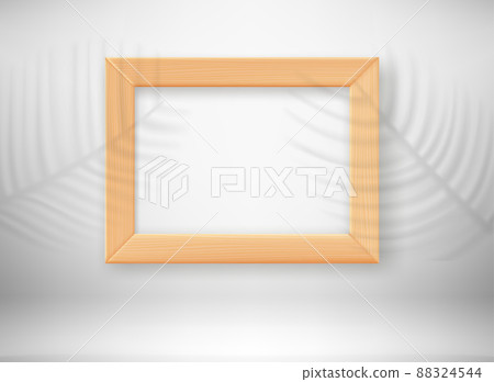 Empty wood frame in interior with palm leaves shadows Empty wood frame in interior with palm leaves shadows 88324544