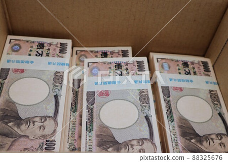 A bundle of bills in a cardboard A bundle of bills in a cardboard 88325676