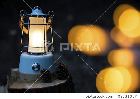 Image of lighting a light with a lantern at night 88331017