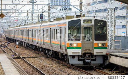 Chuo Line 211 series commuter train arriving at Nagoya Station 88333427