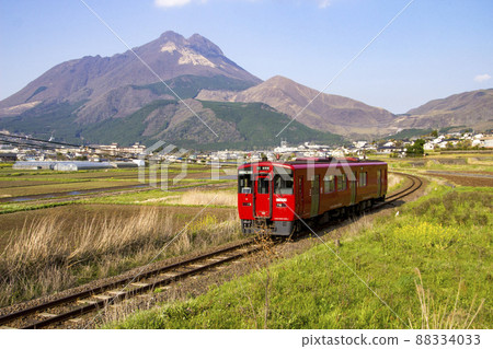 Red train running in Yufuin basin 88334033