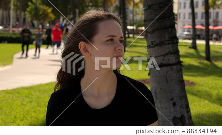 Young woman relaxes in the sun at the promenade of Miami South Beach Young woman relaxes in the sun at the promenade of Miami South Beach 88334194
