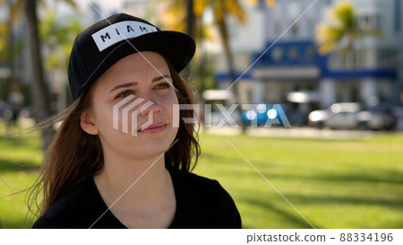 Close up shot of a pretty girl under palm trees at the beach Close up shot of a pretty girl under palm trees at the beach 88334196