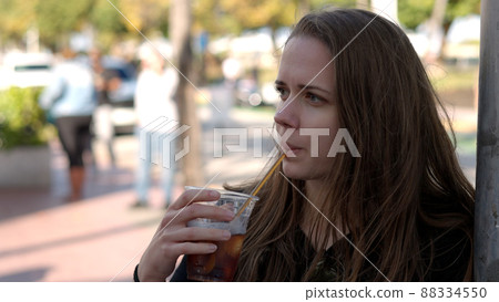 Young pretty woman has a cold drink in the sun of Miami Beach Young pretty woman has a cold drink in the sun of Miami Beach 88334550