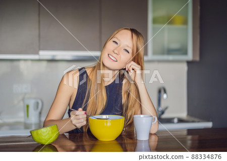 Beautiful woman having coffee and fruits for breakfast 88334876