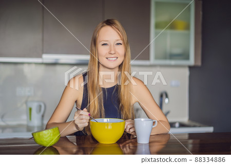 Beautiful woman having coffee and fruits for breakfast 88334886