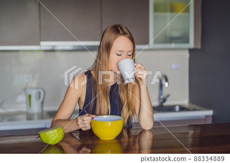 Beautiful woman having coffee and fruits for breakfast 88334889