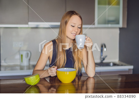 Beautiful woman having coffee and fruits for breakfast 88334890