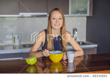 Beautiful woman having coffee and fruits for breakfast 88334891