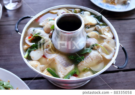 Tom Yum seafood in hot pot on table. Tom Yum seafood in hot pot on table. 88335058