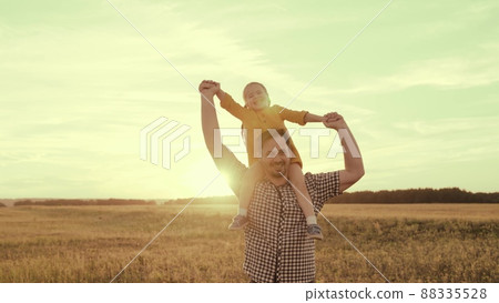happy family sunset. cheerful father carries little kid daughter his shoulders rays sun. dream childhood. dad kid child play park. happy family concept. joyful baby kid girl fun laughing father sun. 88335528