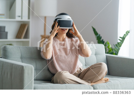 Woman with VR virtual reality goggles 88336363
