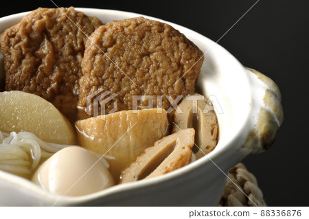 Oden with boiled egg, radish, chikuwa, Jakoten, Shirataki, and kamaboko taken on a black background 88336876