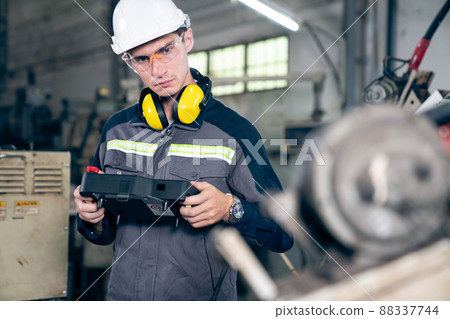 Young factory worker working with adept robotic arm 88337744