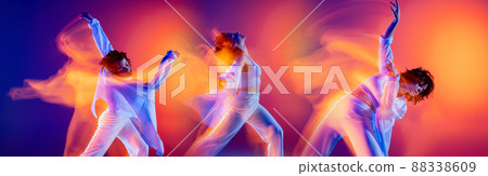 Young flexible girl, hip-hop dancer in white clothes dancing isolated on bright background with mixed neon light. 88338609