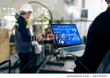 Factory workers working with adept robotic arm in a workshop Factory workers working with adept robotic arm in a workshop 88338845