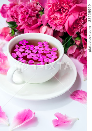 Creative layout with pink peonies flowers and cup of tea on bright table. Spring Seasonal valentine, woman, mother, 8 march holiday, romance breakfast. Stylish blogger. Greeting card 88339949