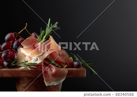 Prosciutto with grapes and rosemary. Prosciutto with grapes and rosemary. 88340588