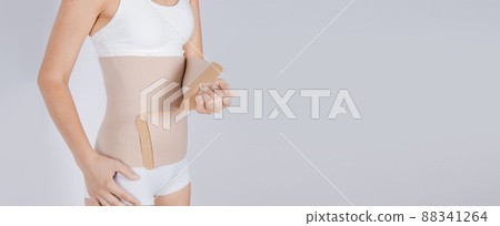 Lumbar brace on the human body isolated on a white background. Trauma of back. Back brace, orthopedic lumbar, support belt for back muscles. Lower back problems health. 88341264
