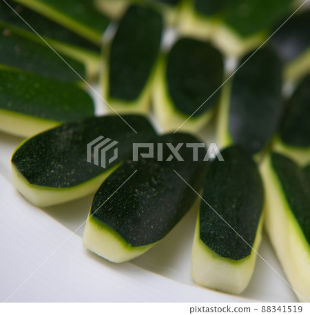 Preparing fresh courgette, zucchini on wood table 88341519