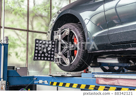 fixing your car at the garage by a mechanic fixing your car at the garage by a mechanic 88342121