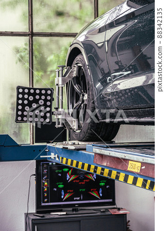 fixing your car at the garage by a mechanic fixing your car at the garage by a mechanic 88342135
