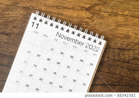 November 2022 desk calendar on wooden background. 88342381