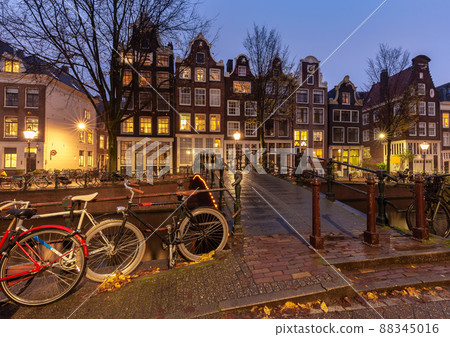 Beautiful old houses on the city waterfront of Amsterdam at sunset. 88345016